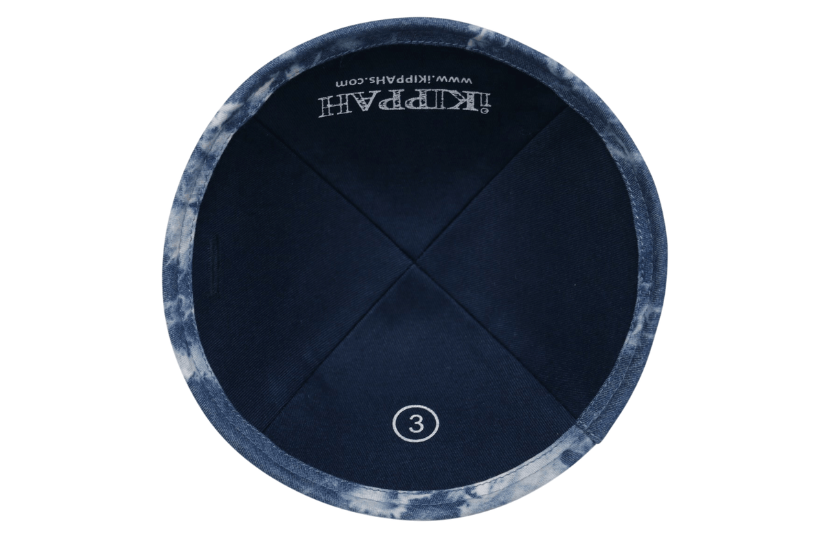 A blue iKIPPAH brand yarmulke with a tie dye pattern inside view.